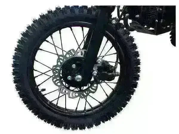 Close-up of youth dirt bike front wheel with knobby tire and disc brake