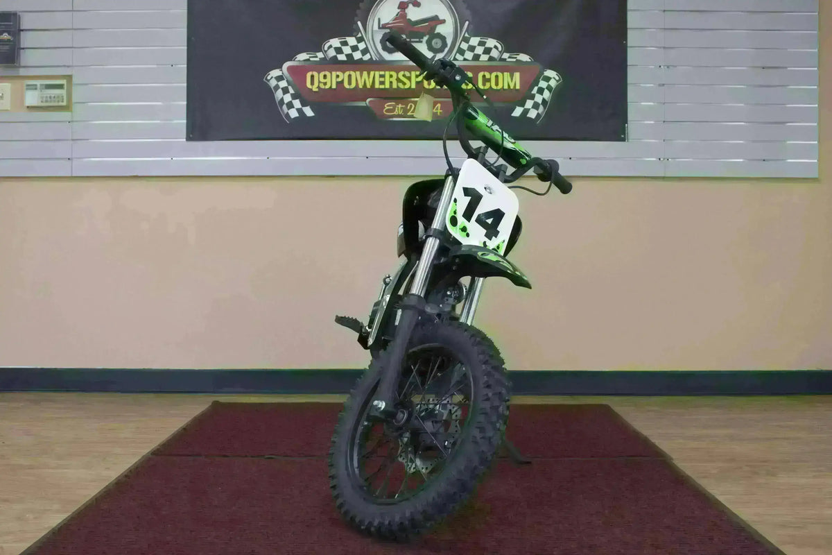 Black youth dirt bike with number 14 plate on indoor showroom display