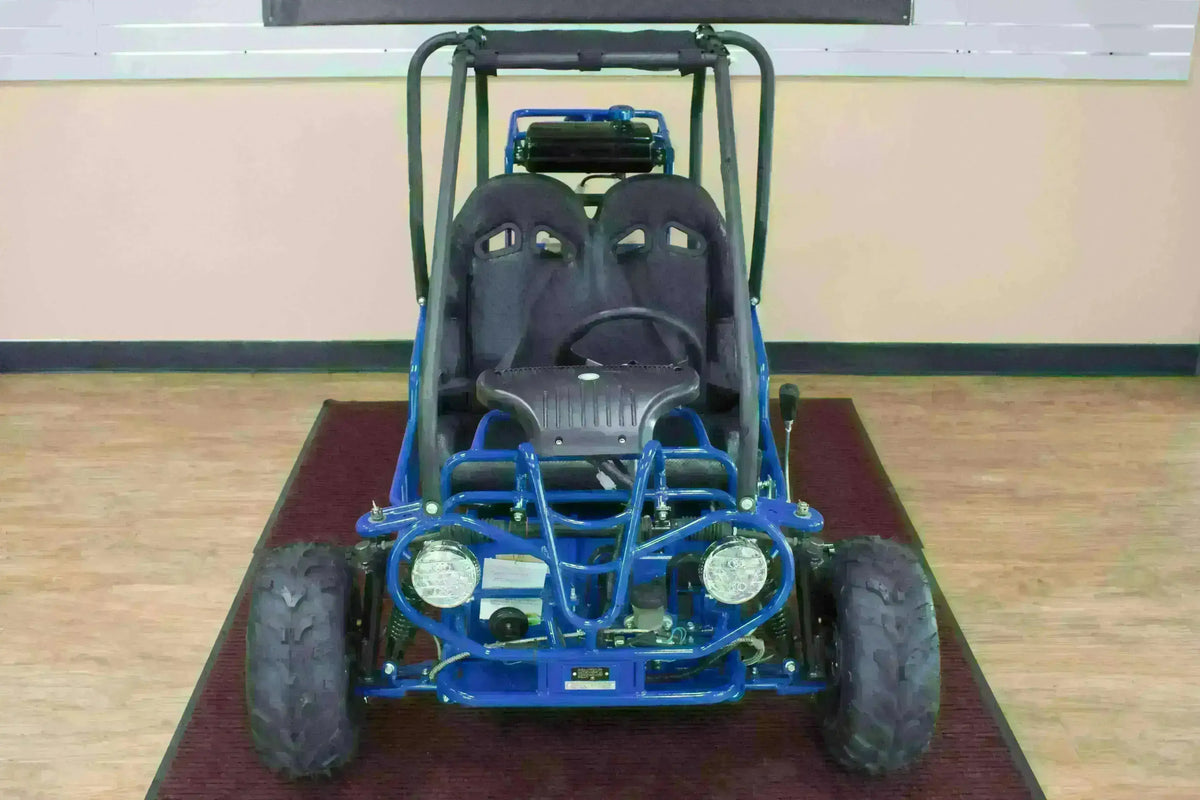 Blue double seat 110cc kids go-kart with off-road tires and dual headlights indoors