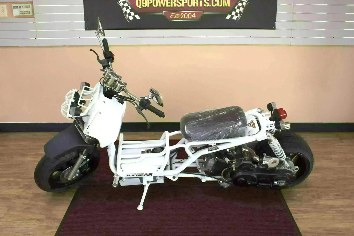White Icebear Maddog 50cc scooter with exposed frame and black wheels indoors