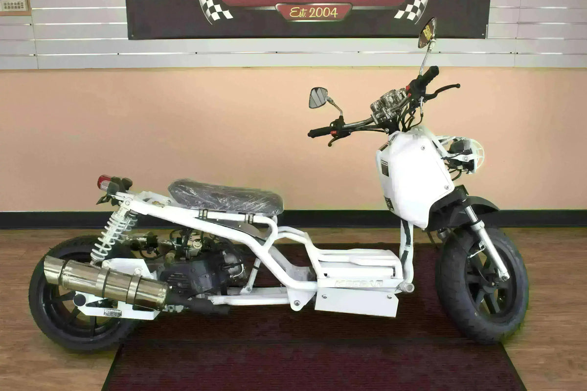 White 50cc Maddog scooter with exposed frame and large tires on showroom floor