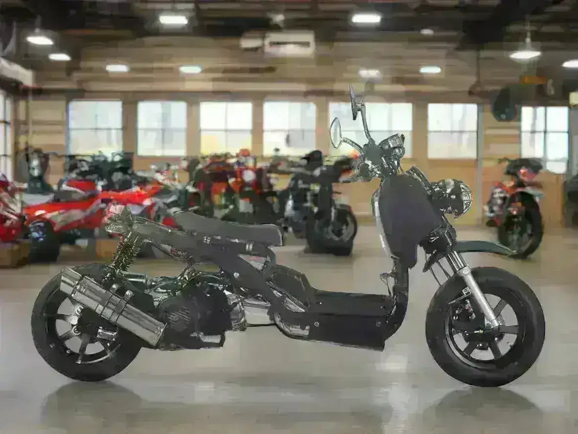 Black 50cc scooter with exposed frame and large exhaust on showroom floor with other powersports vehicles