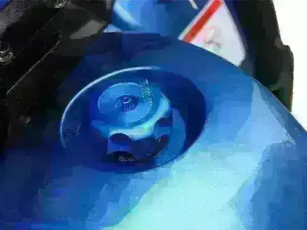 Close-up of blue ATV gas tank cap, youth utility four wheeler detail.