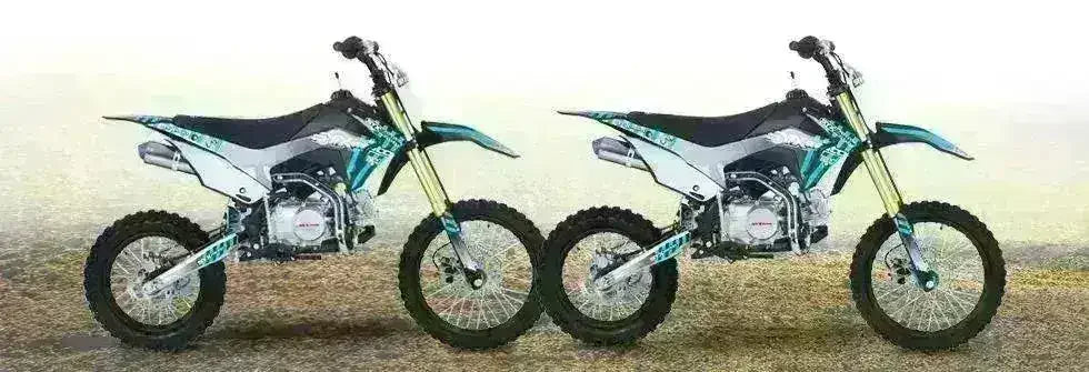 Two Icebear Whip 125cc youth dirt bikes with blue and white graphics, side by side outdoors