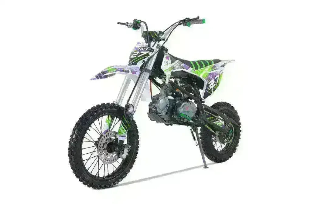 125cc youth dirt bike with knobby tires and green, black, and white graphics on white background