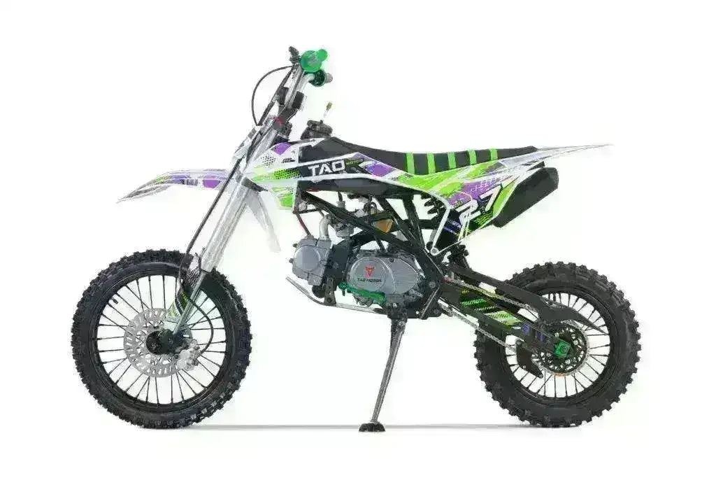 Green and purple 125cc youth dirt bike with off-road tires on a white background