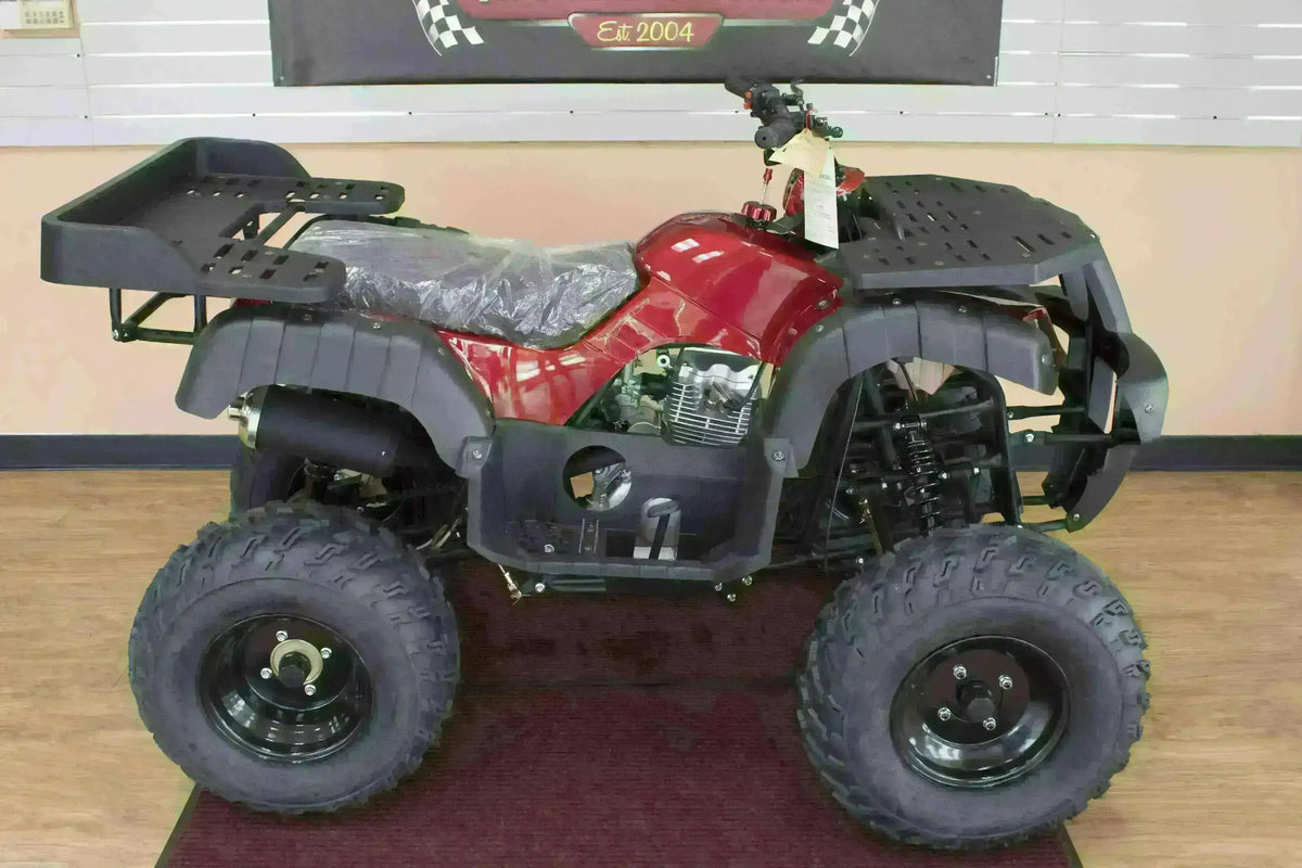 Right-side view of a red Rhino 250 utility ATV showing exhaust, engine and black cargo racks in the showroom