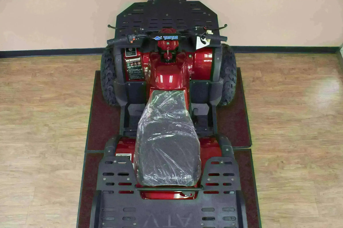 Top view of a red Rhino 250 utility ATV showing plastic-covered seat, handlebars and front and rear cargo racks
