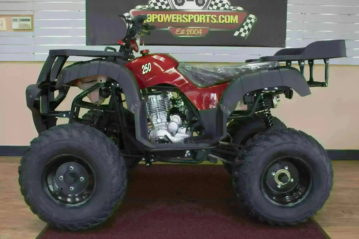 Red Rhino 250 utility ATV with black cargo racks and plastic-covered seat, left-side view in the showroom