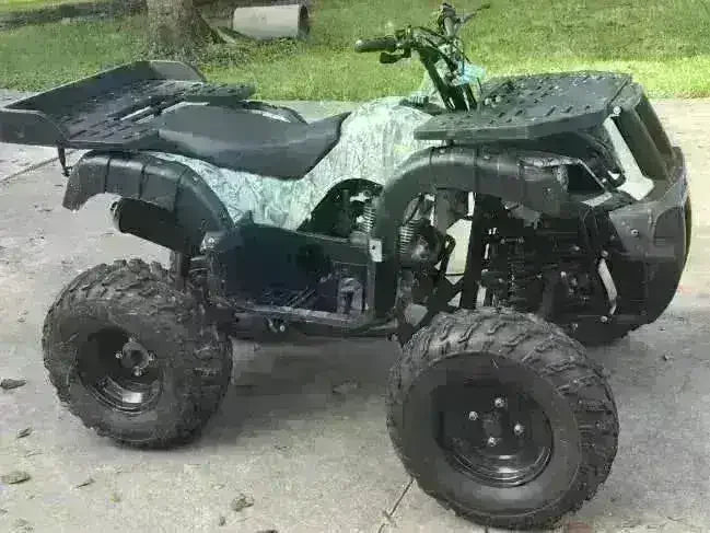 Camouflage Rhino 250 utility ATV with black cargo racks and fenders, right-side three-quarter view outdoors