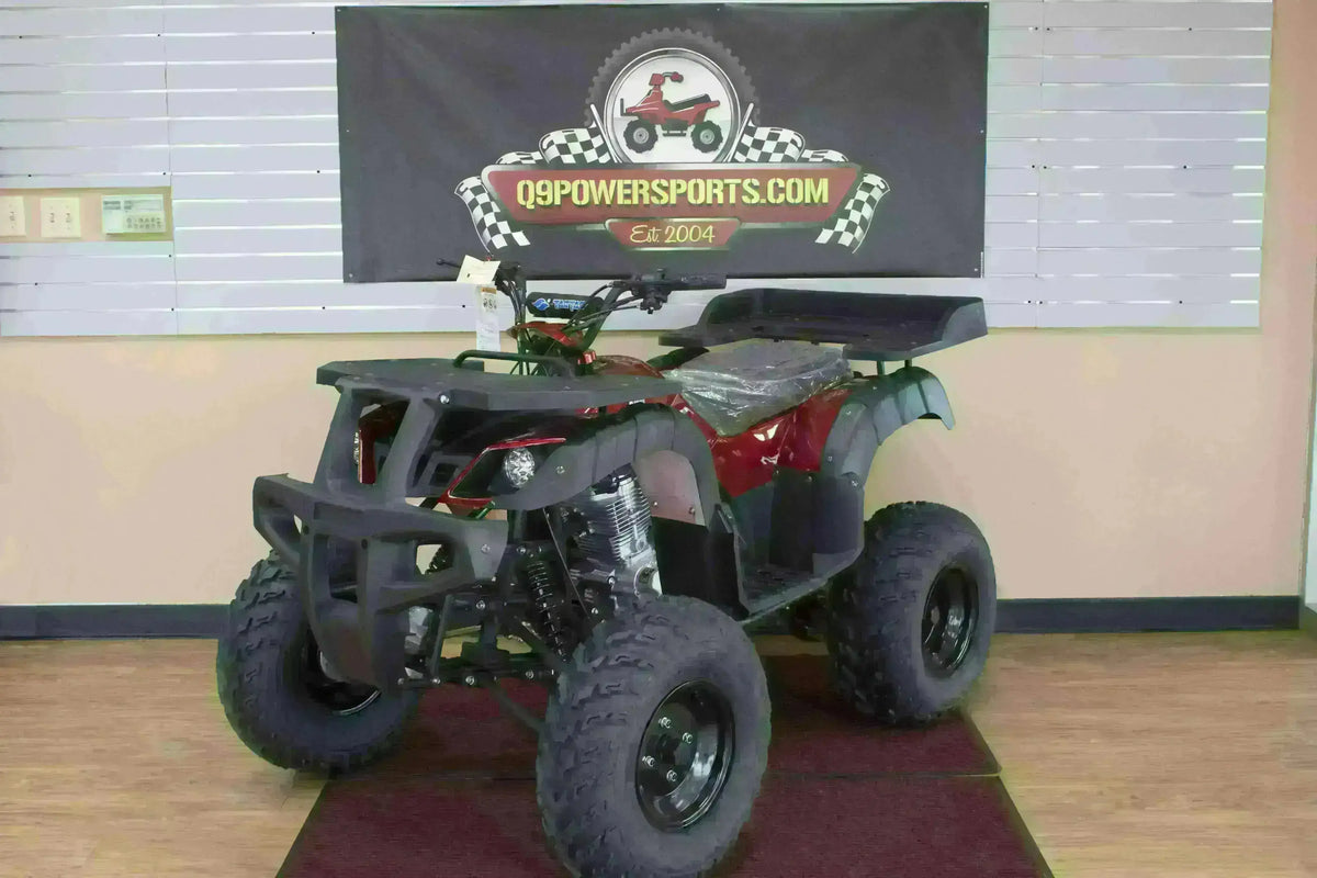 Red Rhino 250 utility ATV with plastic-covered seat and black cargo racks, front three-quarter view in the showroom