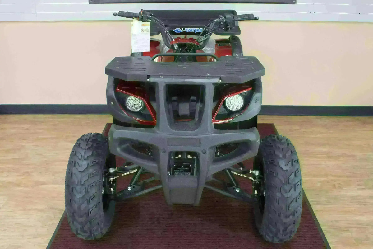 Front view of a red Rhino 250 utility ATV showing round headlights, cargo rack and black bumper in the showroom