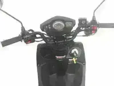 Black scooter dashboard with speedometer and handlebar controls, close-up view