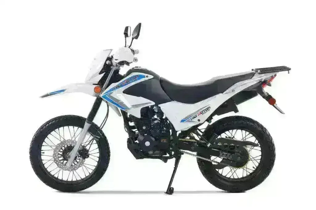White and blue 250cc dual sport motorcycle with off-road tires and rear rack, side view