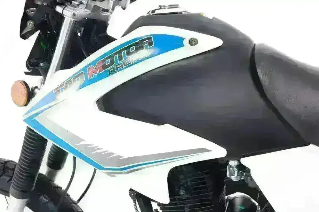 Close-up of a blue and white 250cc off-road motorcycle with visible side panel details