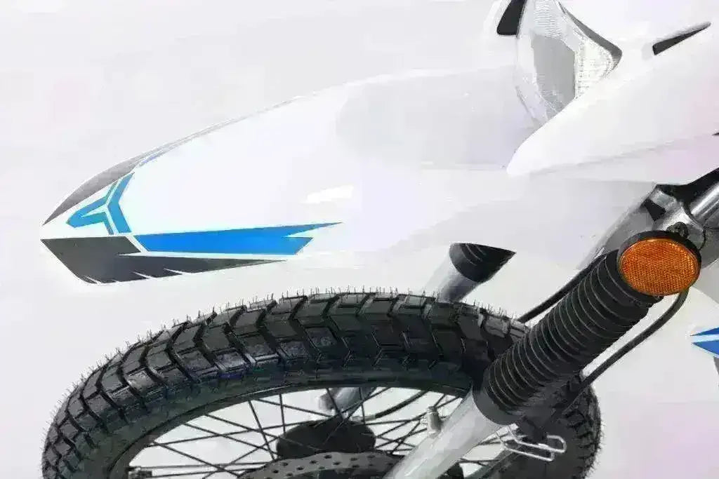 Close-up of white and blue dual sport motorcycle front fender, tire, and turn signal