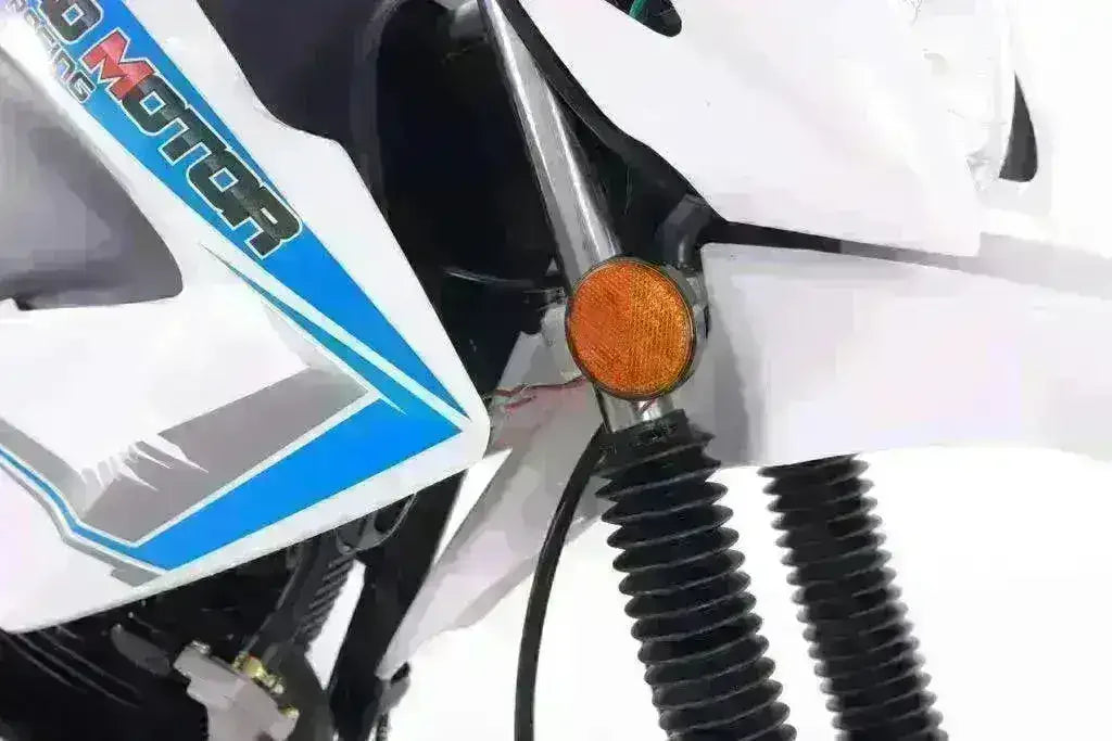Close-up of a white and blue 250cc motorcycle front fork with orange reflector