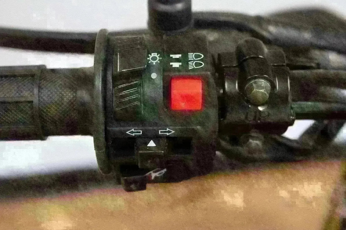 Close-up of RPS Hawk 250cc dirt bike handlebar switch with headlight and turn signal controls