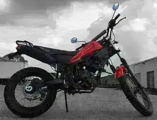 Red and black 250cc enduro dirt bike parked outdoors on pavement