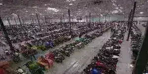 Large warehouse with rows of all-terrain vehicles and dirt bikes on display