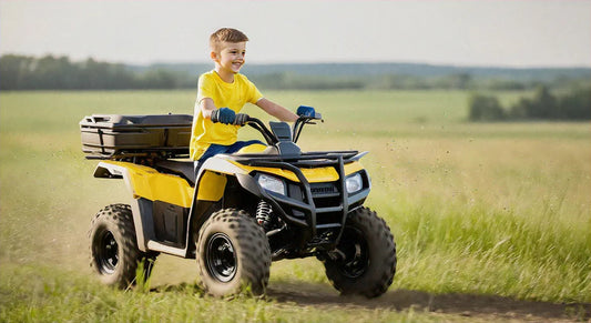 Smiling child riding yellow ATV on grassy field, youth off-road four wheeler outdoors