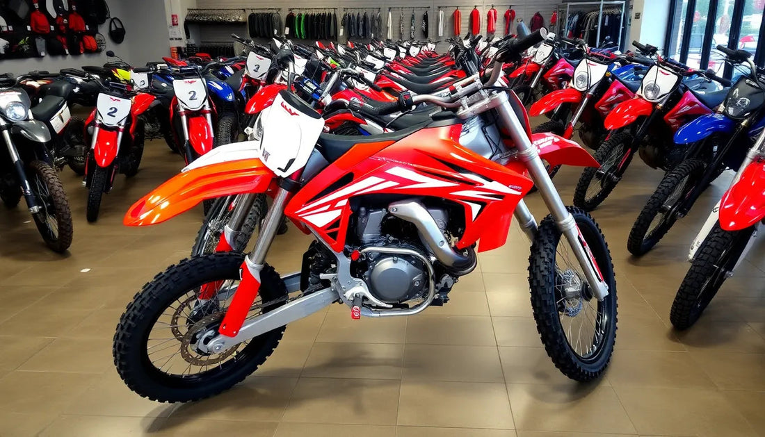 Red dirt bike with off-road tires displayed in a showroom with multiple motorcycles