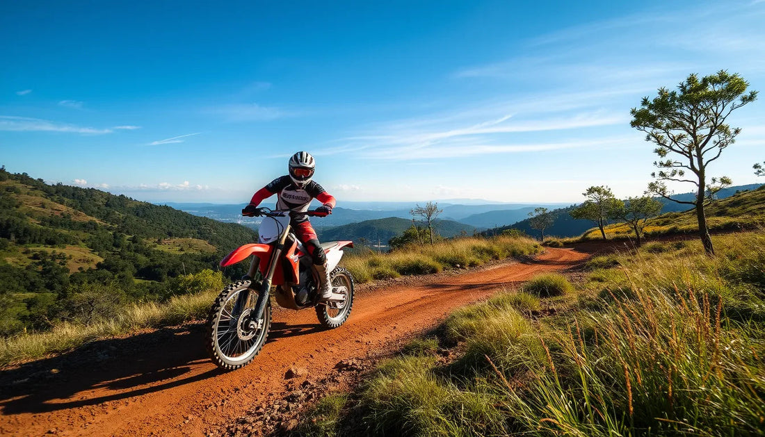 Rider on red dirt bike on scenic mountain trail under blue sky, off-road adventure.