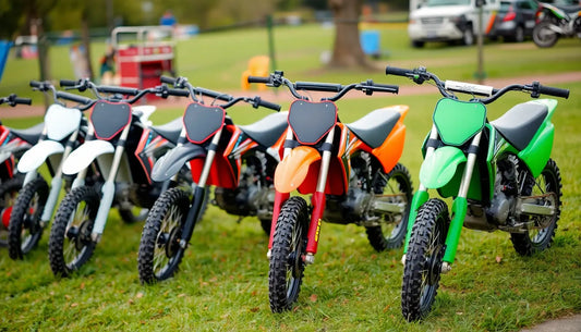 Row of colorful dirt bikes for kids and adults on grass, outdoor powersports vehicles