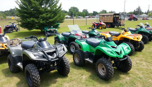Outdoor display of ATVs in various colors, parked on grass under a tree.