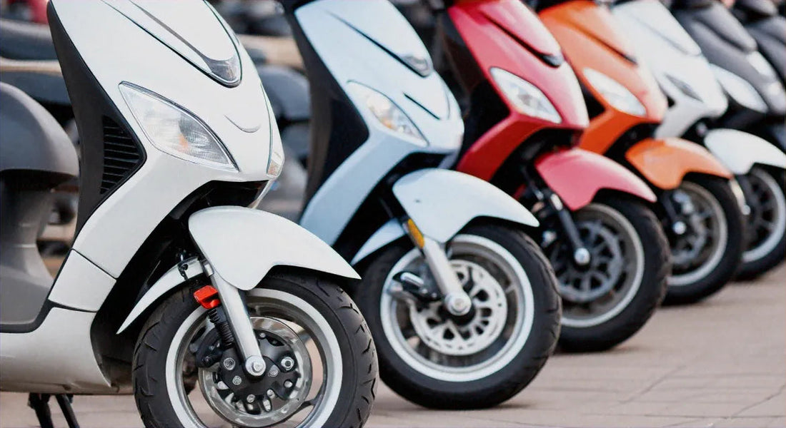 Row of colorful scooters parked outdoors, showcasing front wheels and sleek urban design.