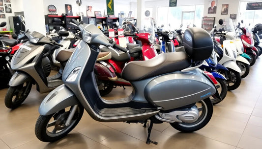 Gray scooter with storage box in a showroom with multiple scooters on display