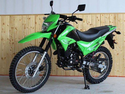Green 250cc enduro dual sport motorcycle with off-road tires in indoor showroom