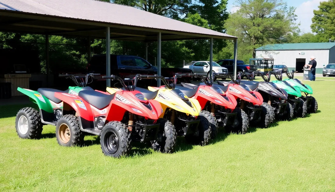 Row of colorful youth ATVs parked on grass at an outdoor dealership lot