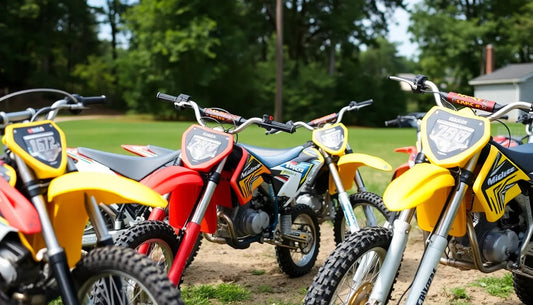 Colorful dirt bikes parked outdoors on grass, ready for off-road riding