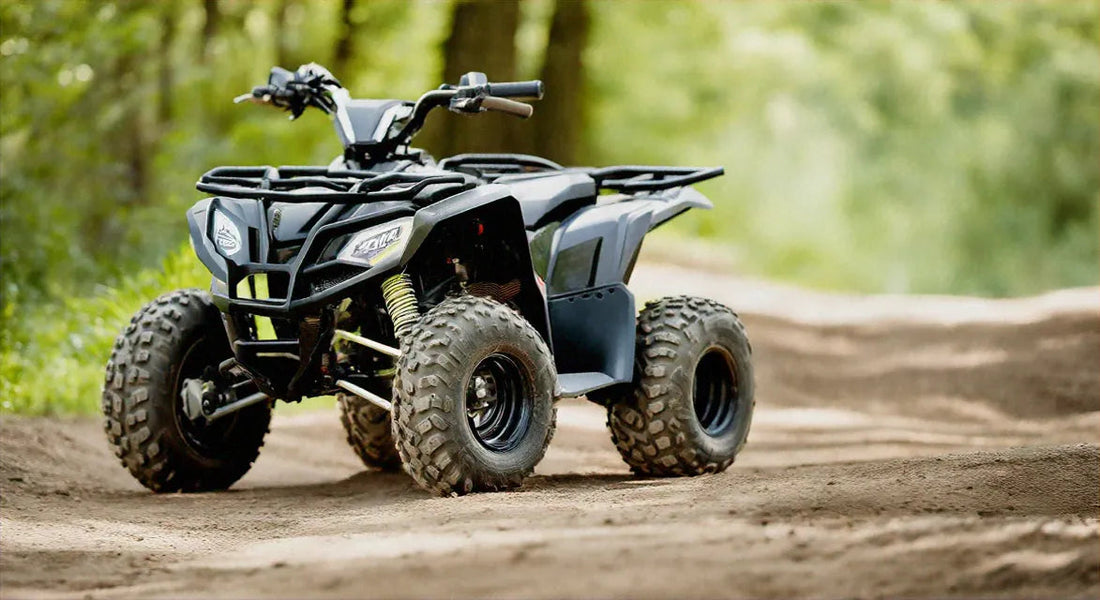 Black ATV quad bike parked on a dirt trail in a forest setting
