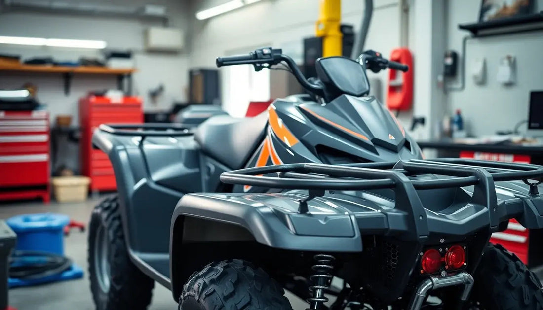 Gray ATV with orange accents parked in a workshop, featuring rugged tires and rear cargo rack