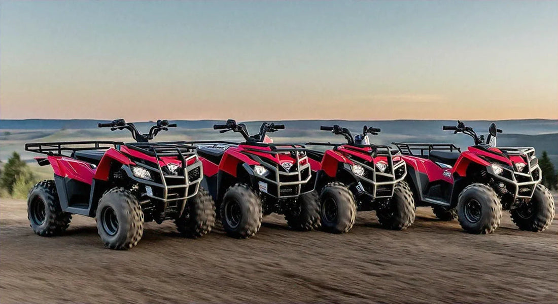 Four red ATVs parked on a dirt trail at sunset with mountains in the background
