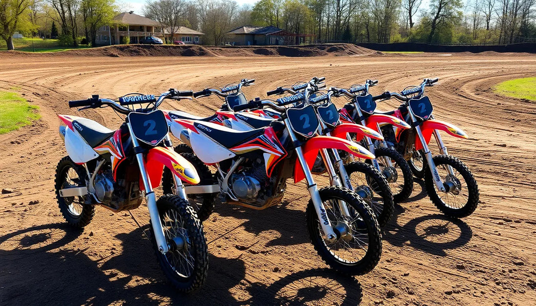 Row of red dirt bikes with number plates on a dirt track outdoors