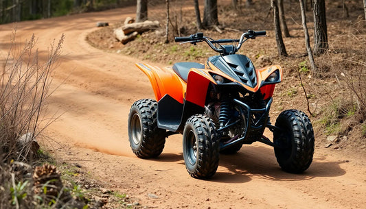 Orange youth ATV riding on a dirt trail in a wooded area with dry foliage