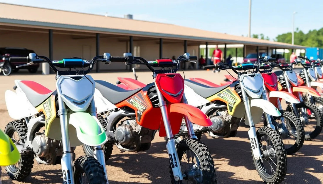 Row of kids’ dirt bikes with colorful fairings and knobby tires parked outdoors