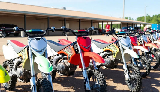 Row of kids’ dirt bikes with colorful fairings and knobby tires parked outdoors