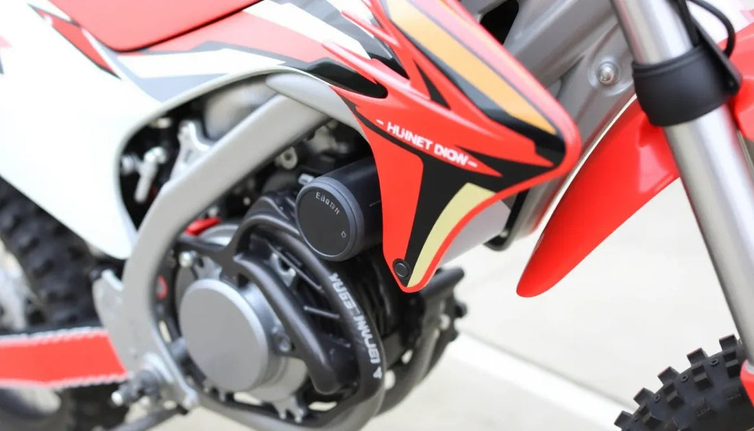 Close-up of red and black dirt bike engine, off-road tire, and front suspension