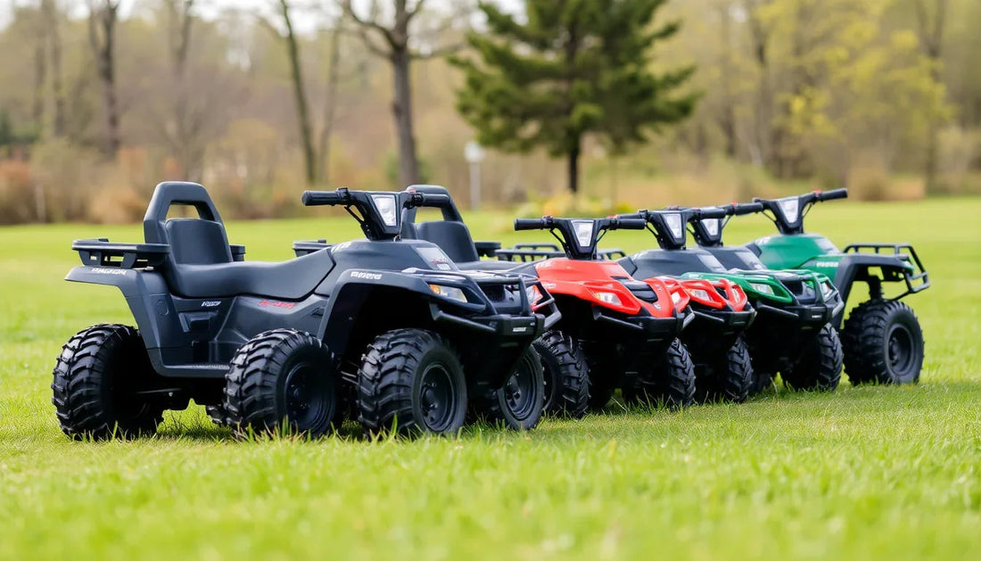 Four kids' ATVs in black, red, camo, and green lined up outdoors on grass