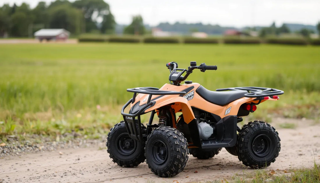 Youth orange ATV quad bike on dirt path with off-road tires, outdoor field background