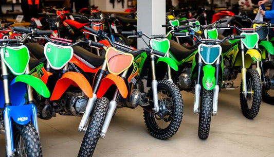 Row of colorful dirt bikes in a showroom, featuring green, orange, and blue models.