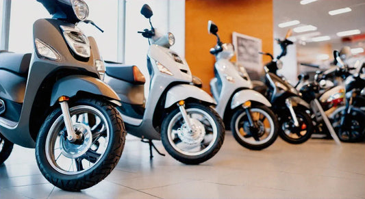 Row of modern scooters on showroom floor, affordable scooters for sale