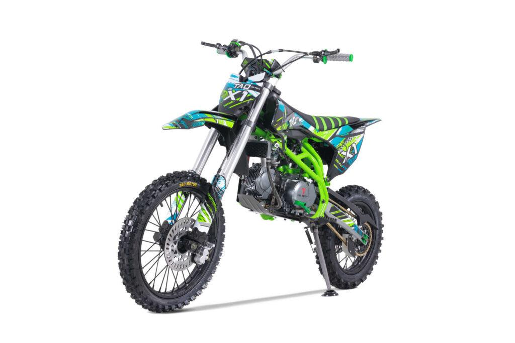Green and black dirt bike with off-road tires and sporty graphics on white background