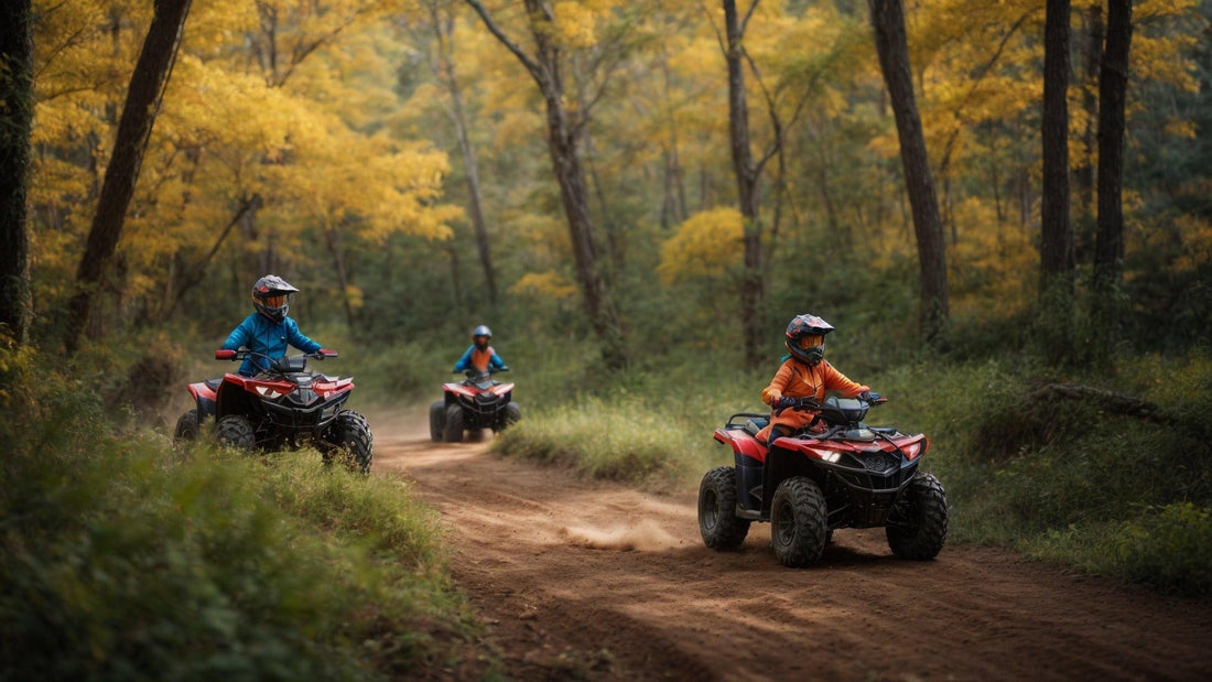 Kids riding ATVs on a dirt trail in a forest with fall foliage, wearing helmets and gear