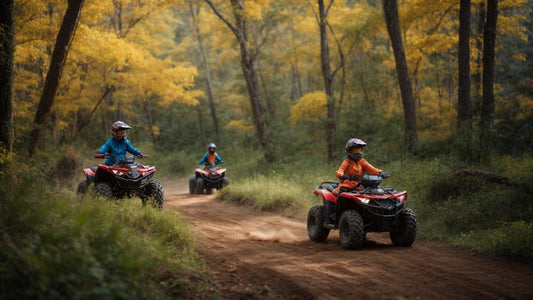 Kids riding ATVs on a dirt trail in a forest with fall foliage, wearing helmets and gear