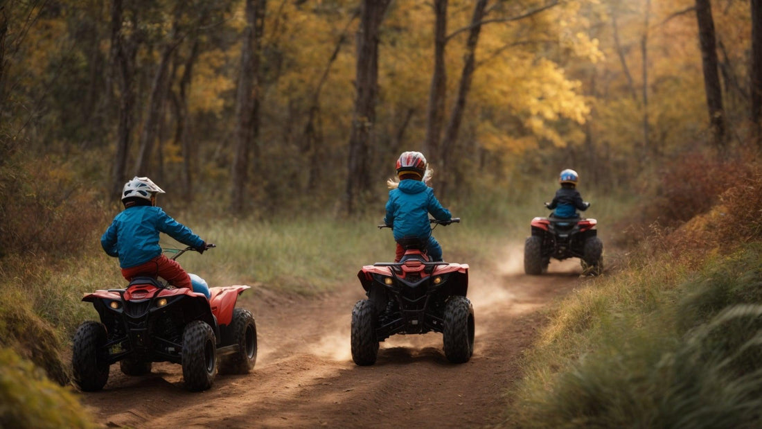 Kids riding youth ATVs on a dirt trail through a forest in autumn, wearing helmets and jackets.